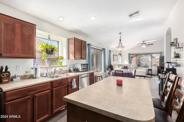 kitchen featuring stainless steel dishwasher, ceiling fan, dark wood-type flooring, a center island, and hanging light fixtures