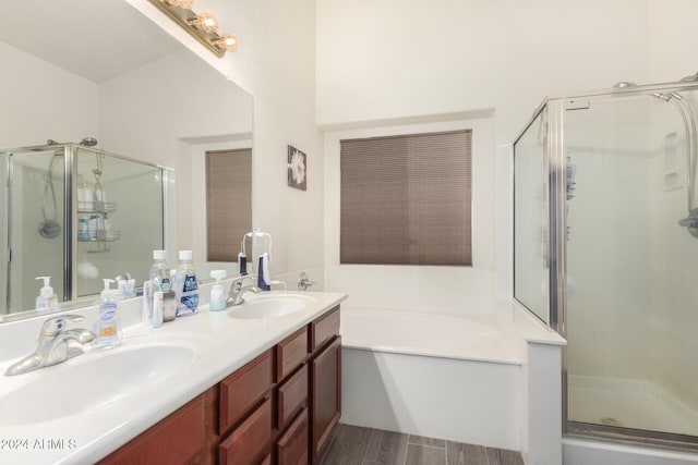 bathroom featuring wood-type flooring, vanity, and independent shower and bath