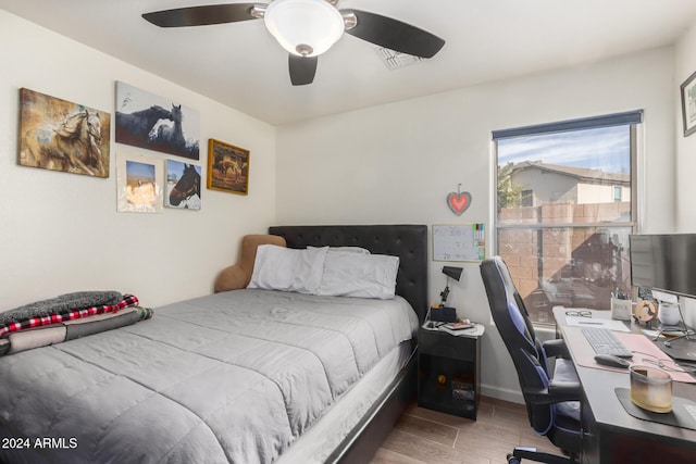 bedroom with hardwood / wood-style flooring and ceiling fan