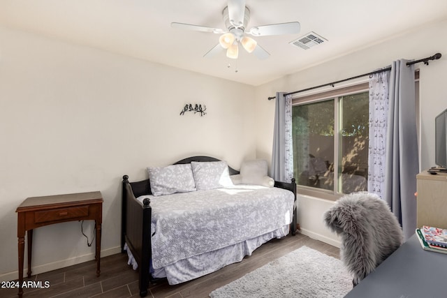 bedroom with ceiling fan and dark wood-type flooring