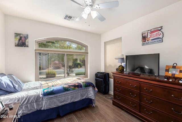 bedroom with ceiling fan and dark wood-type flooring