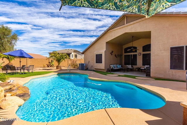 view of pool with central AC, ceiling fan, and a patio area