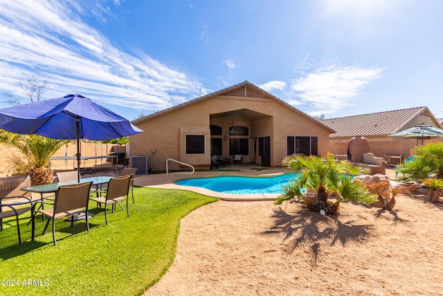 view of pool featuring a lawn and a patio area