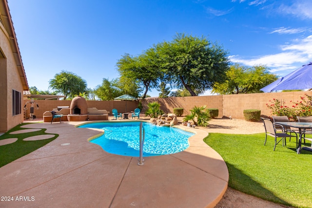 view of swimming pool featuring a yard and a patio