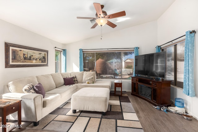 living room with ceiling fan, plenty of natural light, vaulted ceiling, and hardwood / wood-style flooring