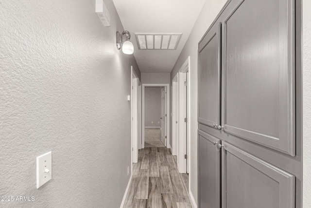 hallway with light hardwood / wood-style flooring