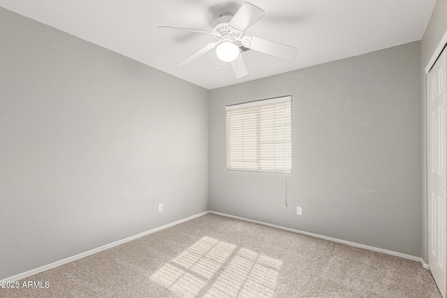 unfurnished room with light colored carpet and ceiling fan