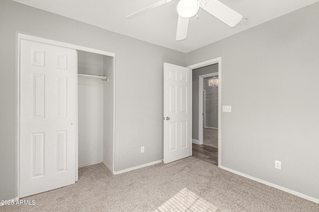 unfurnished bedroom featuring light colored carpet, ceiling fan, and a closet