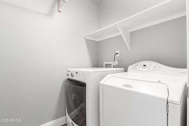 clothes washing area featuring separate washer and dryer