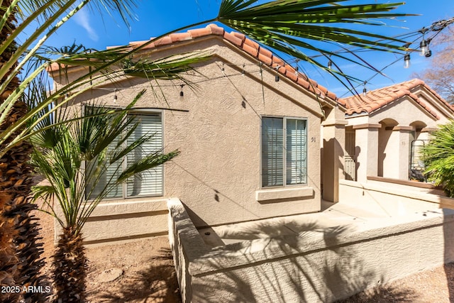 view of property exterior with a patio area