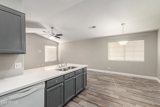 kitchen with hanging light fixtures, sink, white dishwasher, and gray cabinets