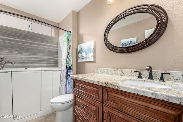 bathroom featuring toilet, vanity, and a shower with curtain