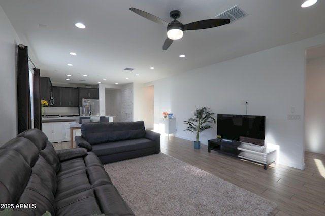 4149 E Appaloosa Rd, Gilbert, AZ 85296 - living room with a ceiling fan, recessed lighting, light wood-style floors, and visible vents