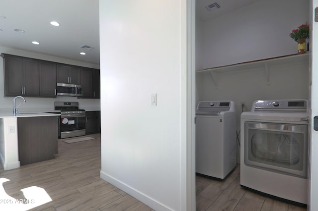4149 E Appaloosa Rd, Gilbert, AZ 85296 - interior space with independent washer and dryer, visible vents, laundry area, and a sink