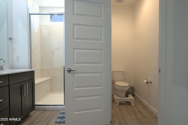4149 E Appaloosa Rd, Gilbert, AZ 85296 - full bathroom with toilet, vanity, a marble finish shower, and wood tiled floor