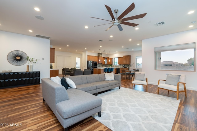 living room featuring dark wood finished floors, visible vents, and recessed lighting