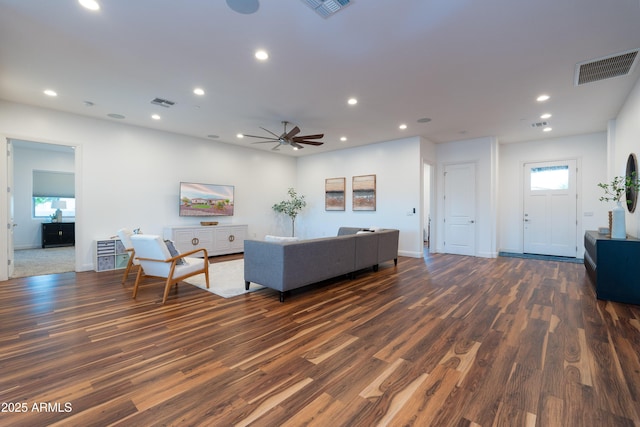living area with recessed lighting, visible vents, and dark wood finished floors