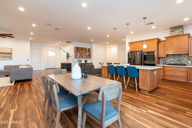 dining area featuring a ceiling fan, visible vents, wood finished floors, and recessed lighting