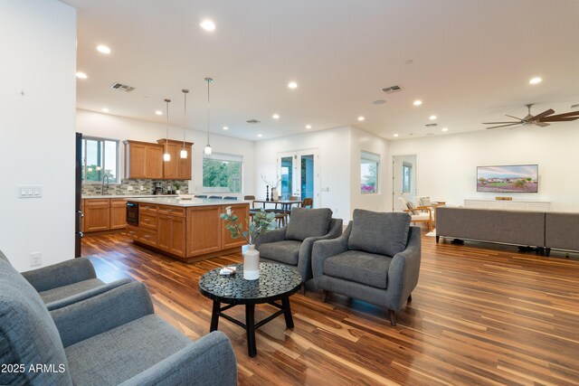 living room with dark wood-style floors, visible vents, and recessed lighting