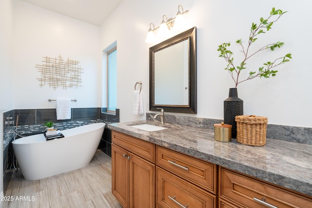 full bathroom with a freestanding tub and vanity