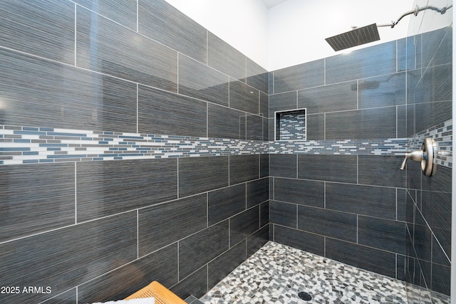 bathroom with tiled shower