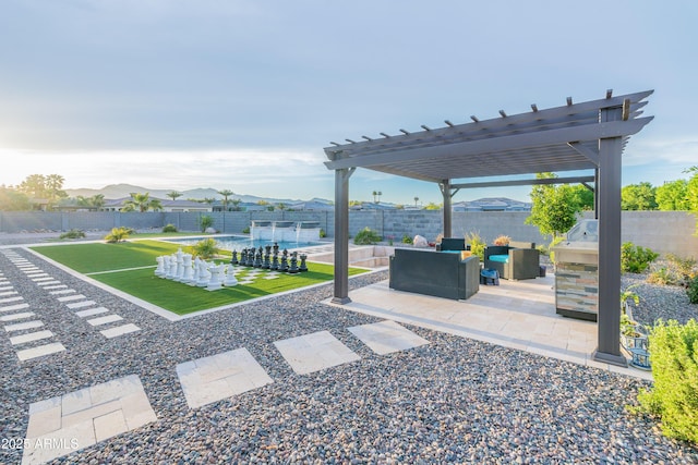 view of patio featuring a fenced backyard, a mountain view, an outdoor living space, and a pergola