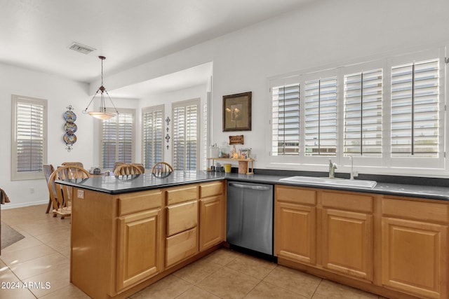 kitchen featuring kitchen peninsula, dishwasher, pendant lighting, and a wealth of natural light