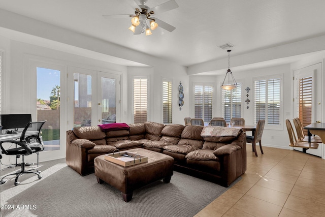 living room with ceiling fan, light tile patterned floors, and a healthy amount of sunlight