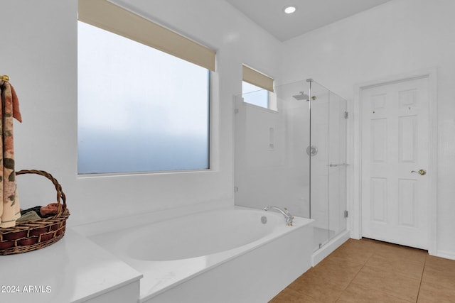 bathroom with independent shower and bath and tile patterned floors