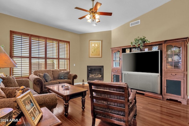 living room featuring light wood-type flooring, lofted ceiling, and ceiling fan