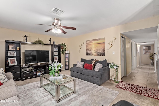 carpeted living area featuring ceiling fan and visible vents