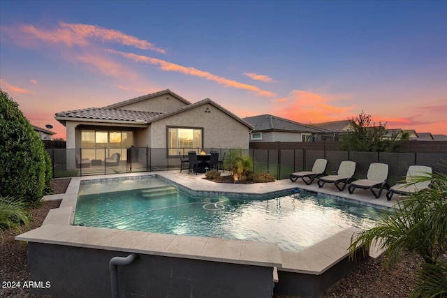 view of pool at dusk