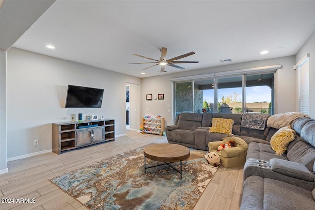 living room featuring ceiling fan and light wood-type flooring