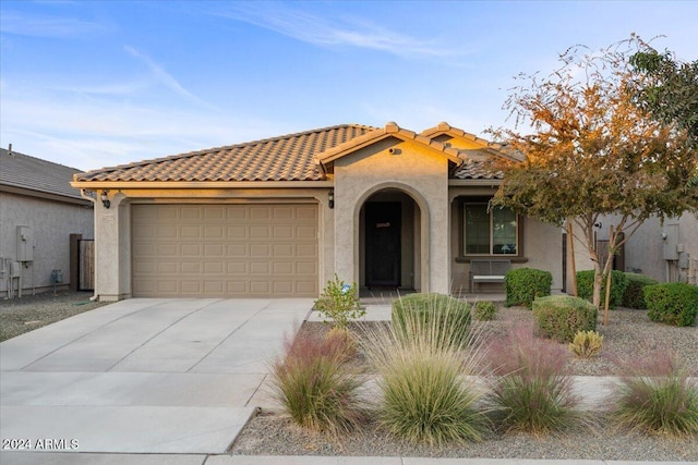 mediterranean / spanish house featuring a garage