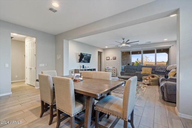 dining space with ceiling fan and light hardwood / wood-style floors