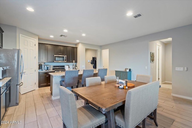 dining area featuring light wood-type flooring