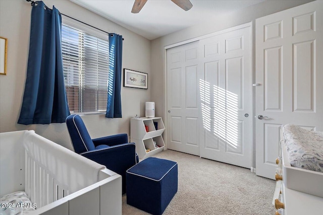 bedroom with light carpet, a closet, and ceiling fan