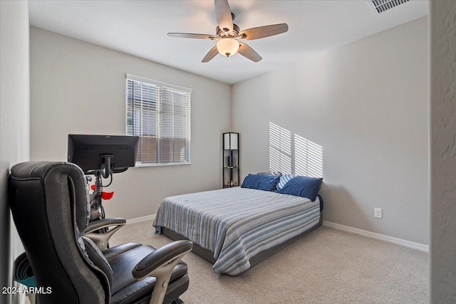 bedroom with ceiling fan and light carpet