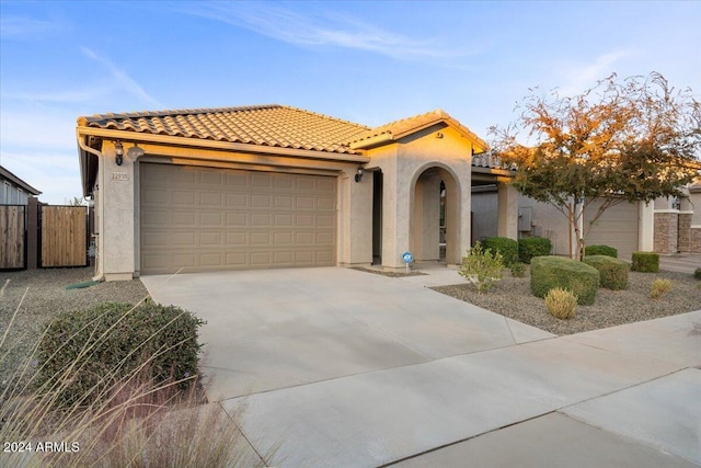 mediterranean / spanish-style home with a garage