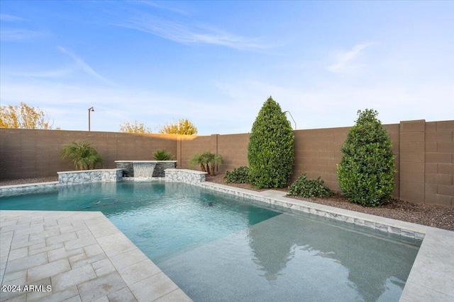 view of swimming pool with pool water feature