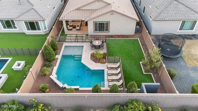 view of swimming pool featuring a patio and a trampoline