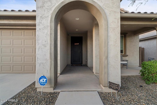 doorway to property with a garage