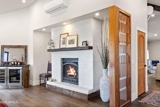 living area featuring an AC wall unit, a towering ceiling, beverage cooler, a bar, and wood finished floors