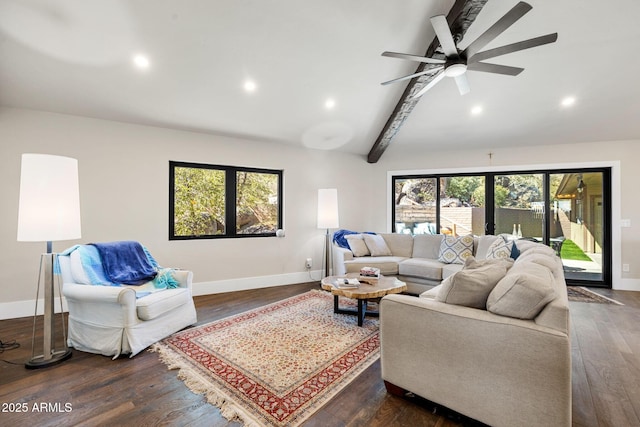 living area with plenty of natural light, lofted ceiling with beams, dark wood-style floors, and baseboards