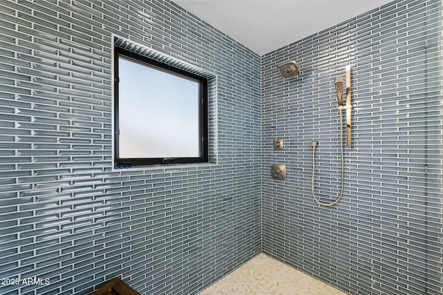 bathroom with a tile shower