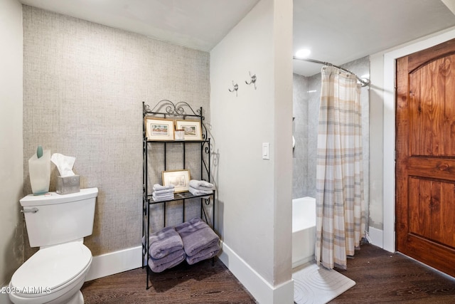 full bathroom with baseboards, shower / bath combination with curtain, wood finished floors, and toilet