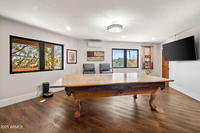 game room with baseboards, wood finished floors, a wall unit AC, and recessed lighting