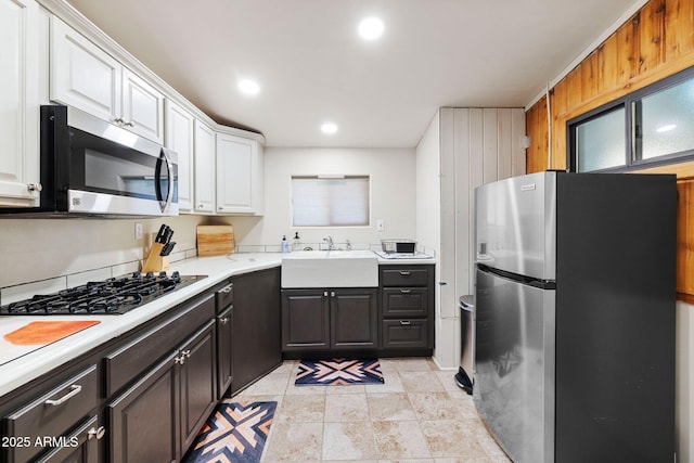 kitchen featuring light countertops, a sink, white cabinetry, appliances with stainless steel finishes, and recessed lighting