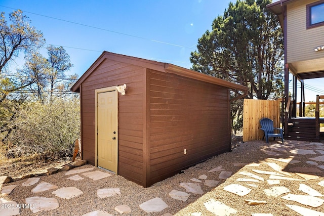 view of shed featuring fence