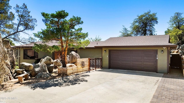 ranch-style home featuring driveway and a garage